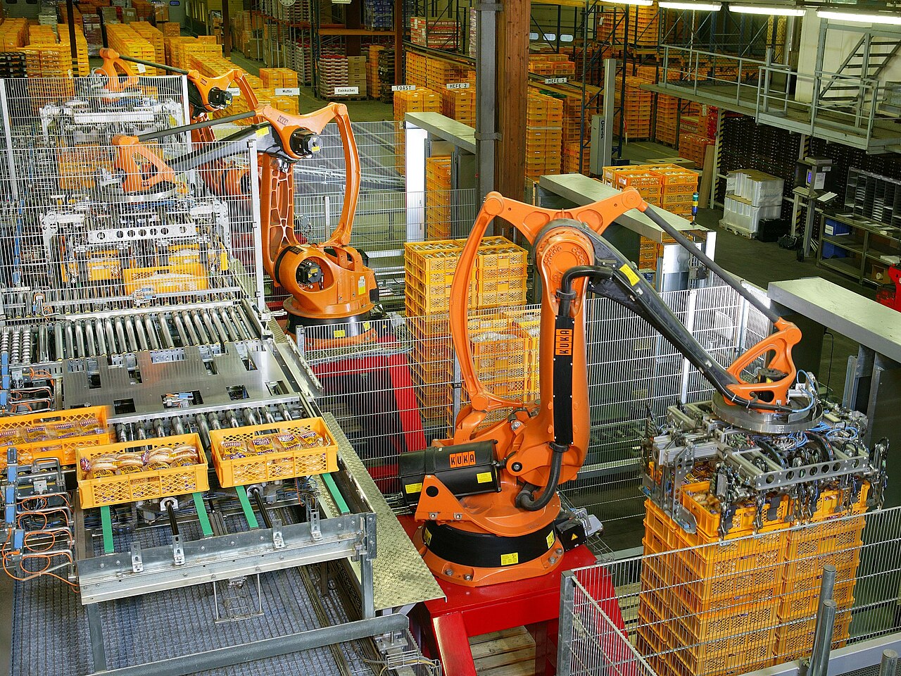 Industrial robots stacking food products in a factory